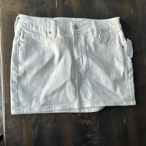 White PacSun Barbie Mini skirt. Cute Barbie button and Barbie detail on waist